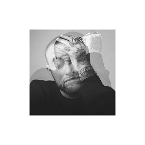 Black and white portrait of Mac Miller with hand over face.