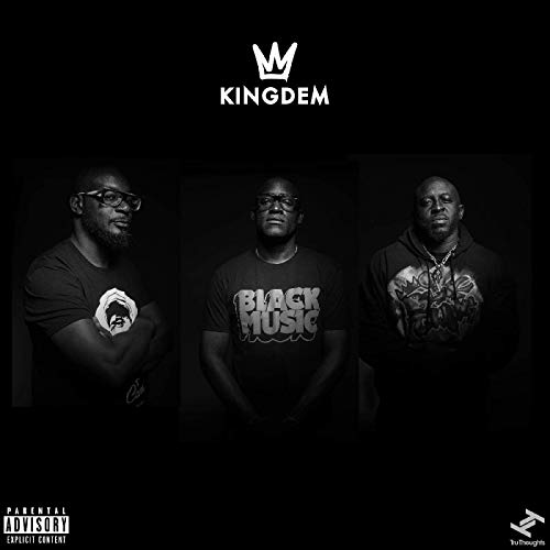 Black and white album cover with three men standing in a dark background.