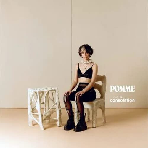 CD cover: Pomme sits in a chair, wearing black clothing.