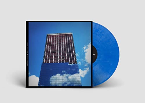 Vinyl record with blue and white album art featuring a tall building.