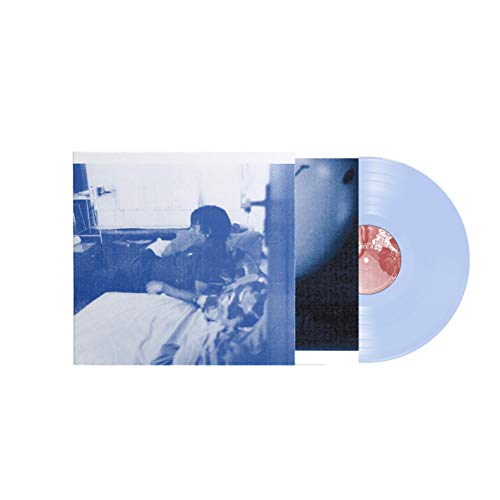 Vinyl record and album cover with a blurry image of a person in bed.