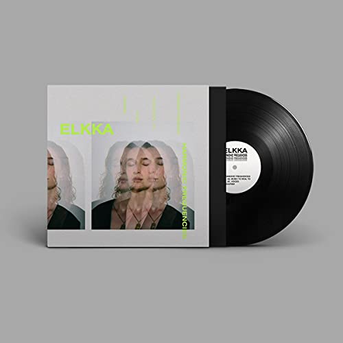 Vinyl record with album cover featuring a blurred portrait of a woman.
