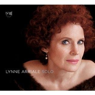 "Lynne Arriale's album cover featuring a woman with red curly hair against a black background."