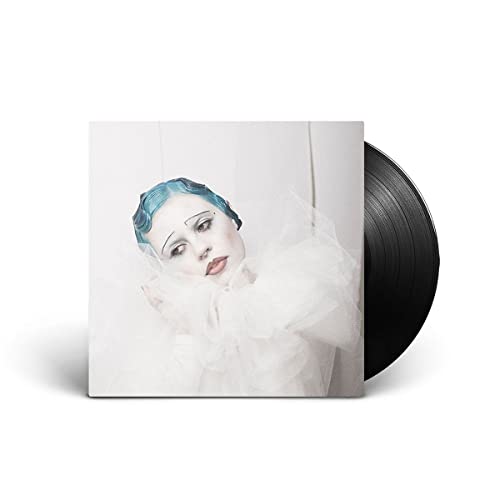 Vinyl record with cover art of a woman in clown makeup.