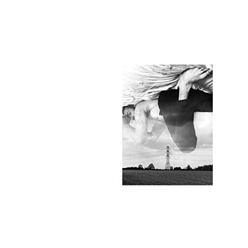 Black and white album cover featuring a man lying in a field.