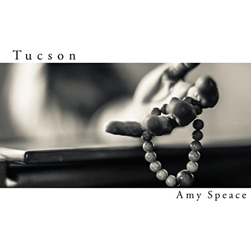 CD cover for Amy Speace’s “Tucson” featuring a hand with beaded bracelet.