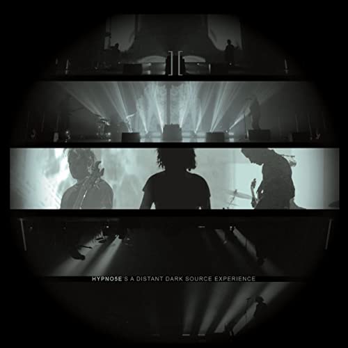 Dark album cover featuring silhouetted musicians and stage lighting.