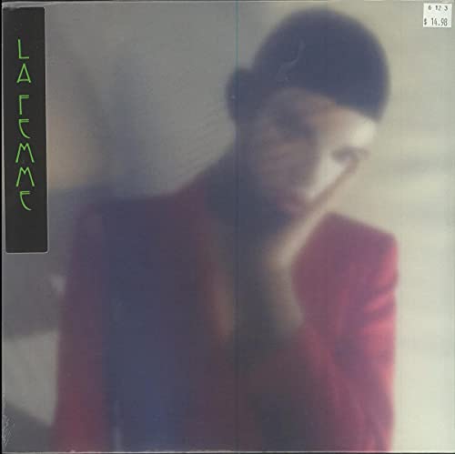 Blurred portrait of a person in a red jacket, face partially obscured.