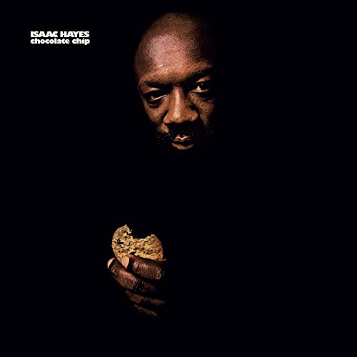 Isaac Hayes portrait holding a chocolate chip cookie, dark background.
