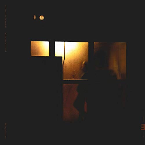Dark abstract image of a doorway with warm, glowing light inside.