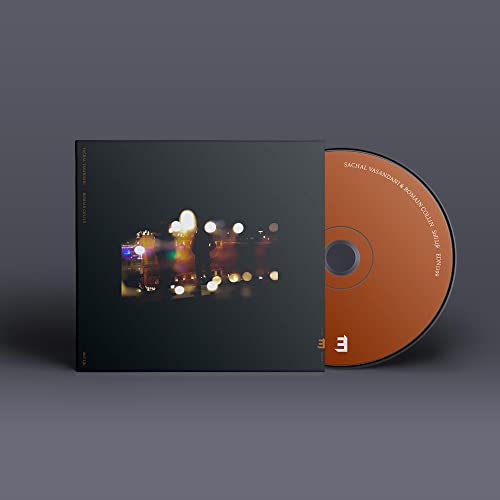 CD case with blurred city lights and exposed disc edge.