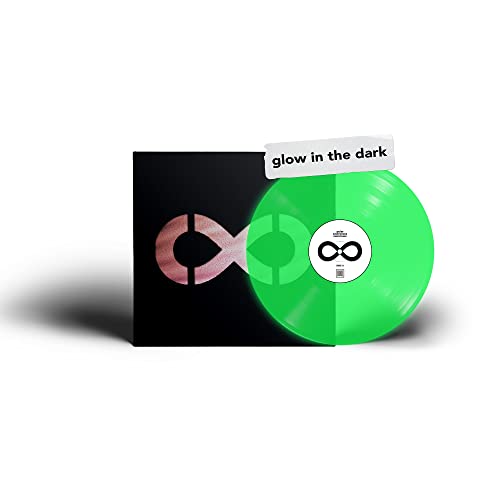 Green and pink swirl vinyl record with black album cover, glow-in-the-dark sticker.