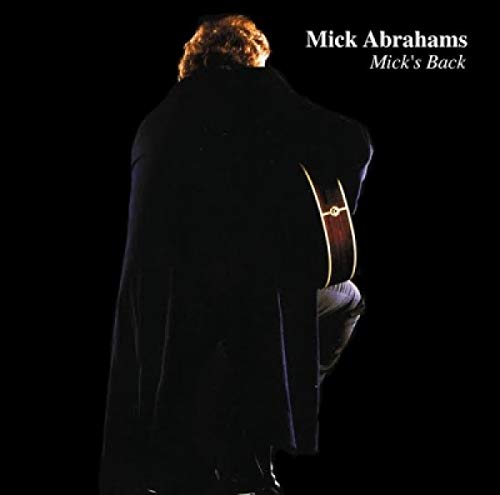 CD cover: Man with guitar seen from behind, dark background.