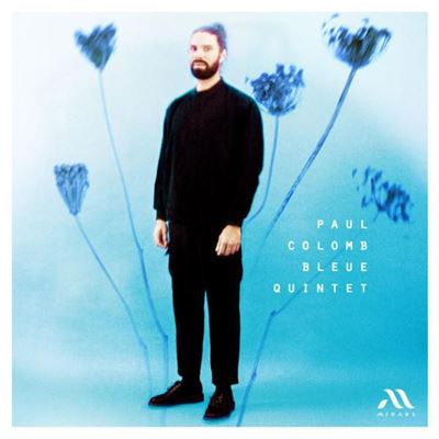 CD cover: man in black suit amidst blue floral graphics.
