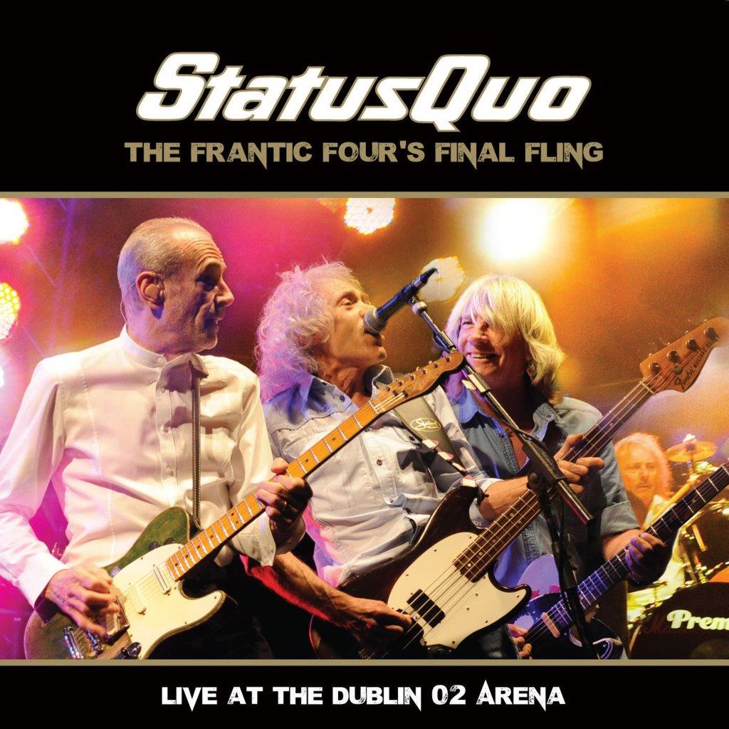 Status Quo band members performing live with guitars at Dublin concert.