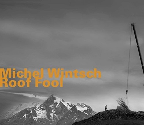 "Album cover: black and white mountain landscape with orange text and Amazon logo."