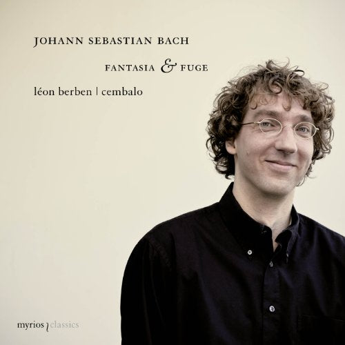CD cover featuring a man with curly hair and glasses against a beige background.