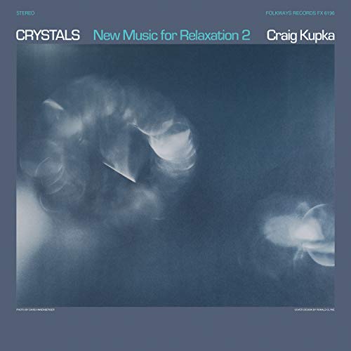 The image shows a vinyl record cover with a blue-toned abstract design. Alt text: Blue-toned vinyl album cover with abstract design and white text.