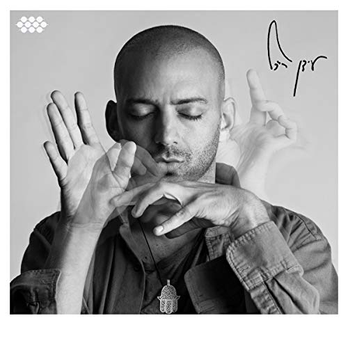 A black and white album cover featuring a man with hands in front of his face.