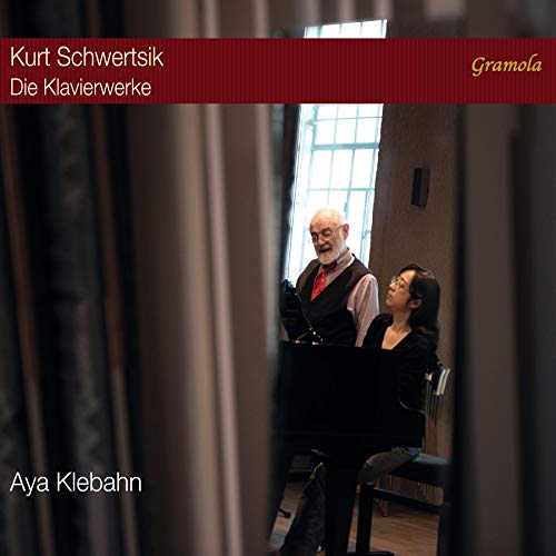 CD cover featuring a man and woman standing beside a piano, indoors.