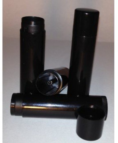"Four black cylindrical objects, some standing upright, others lying down, on a white surface."