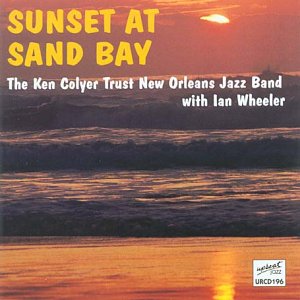 Album cover: "Sunset at Sand Bay" with a serene body of water at dusk.