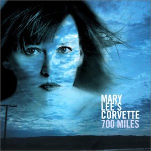 Album cover: a woman's face with cloudy blue sky and power line.