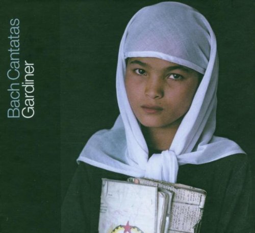 A woman in white headscarf holds a hymnal against a dark green background.