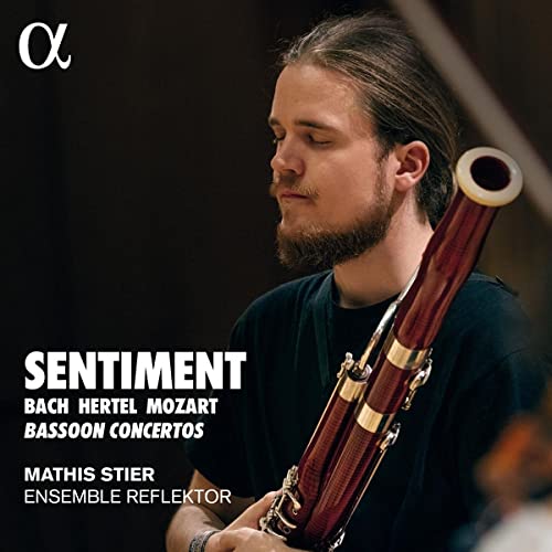 Young man with beard holding a bassoon, album cover for “Sentiment.”