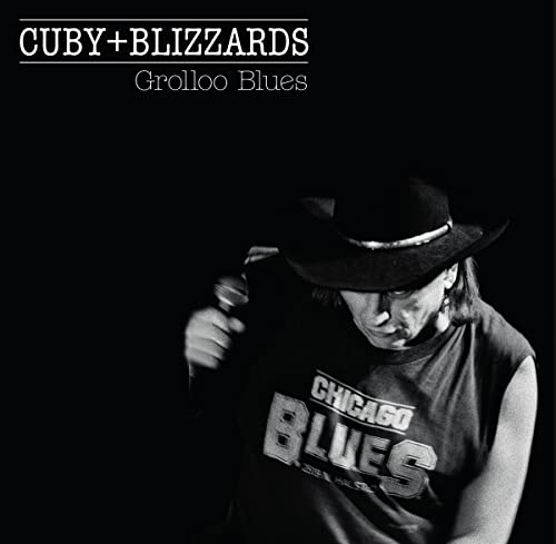 Black and white album cover featuring a singer with a hat and microphone.