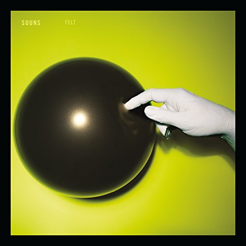 Yellow background with a black balloon and a pale hand touching it.