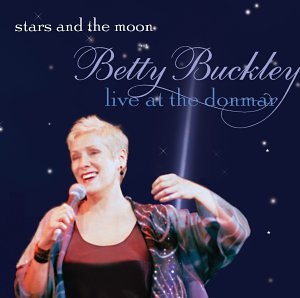 Betty Buckley singing into a microphone on a dark, starry background.