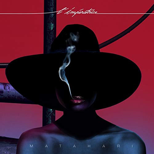 A woman in a black hat exhales smoke against a red background.
