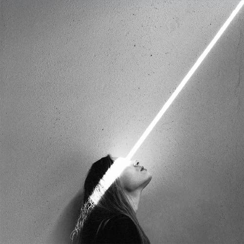 Black and white image of a woman’s profile with a bright light beam.
