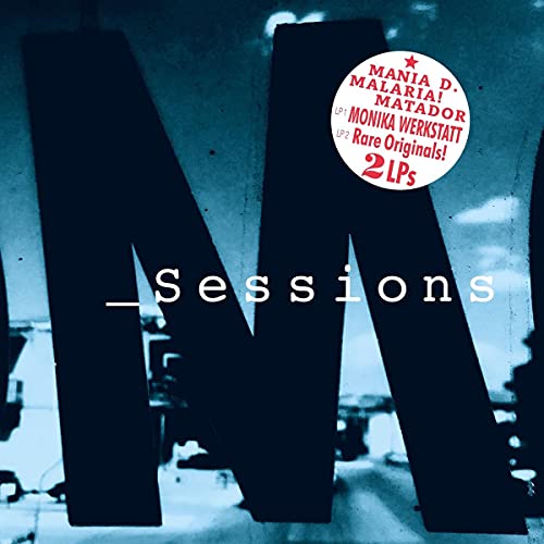Vinyl album cover with large letter “M” and red circular sticker.