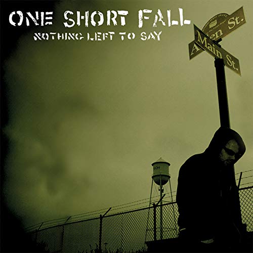 "Album cover with a silhouette of a person holding a guitar beside a street sign."