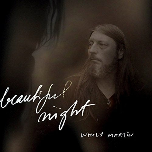 "CD cover with a man and 'beautiful night' written in white cursive."