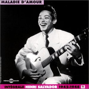 Black and white album cover with man playing guitar, wearing white suit.