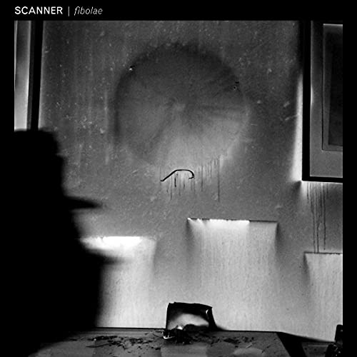 Black and white vinyl record cover with abstract, shadowy interior scene.