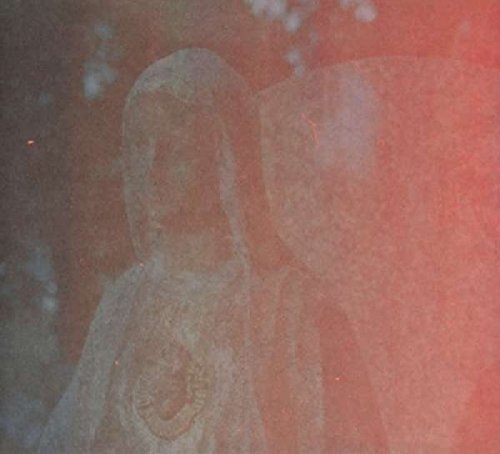 A faded image of a religious statue with a hooded figure and large wings.