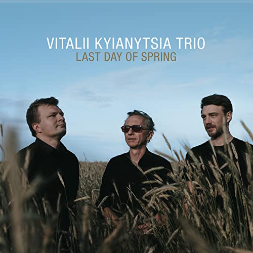 CD cover featuring three men in a field of tall grass.