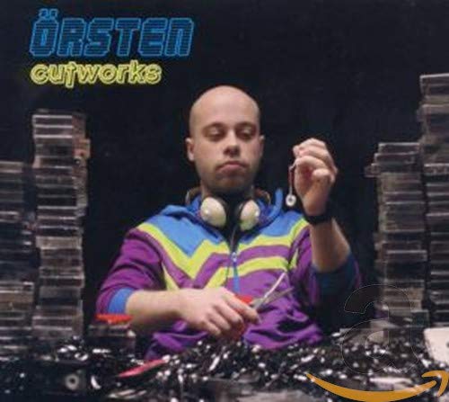 CD cover: Man with headphones cutting tape amidst stacks of cassettes.