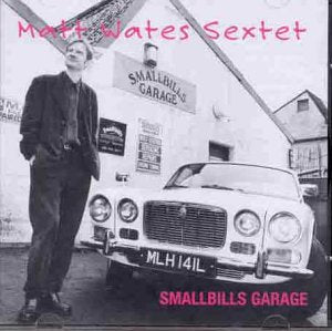 Black and white album cover with man standing beside a car in front of a garage.
