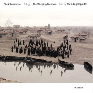 A sepia-toned album cover with a village scene and people gathered near boats.