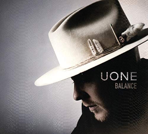 A man wearing a white hat with feathers, titled "Uone Balance".