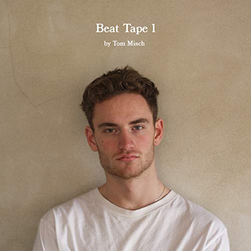 "Vinyl record album cover with a man in a white shirt and album title."