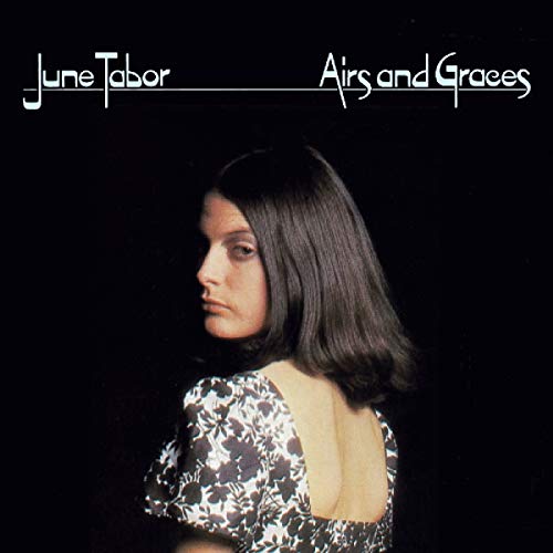 "Album cover featuring a woman with dark hair against a black background."
