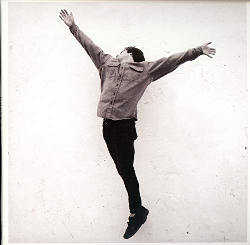 Black and white CD cover featuring a man jumping with arms raised.