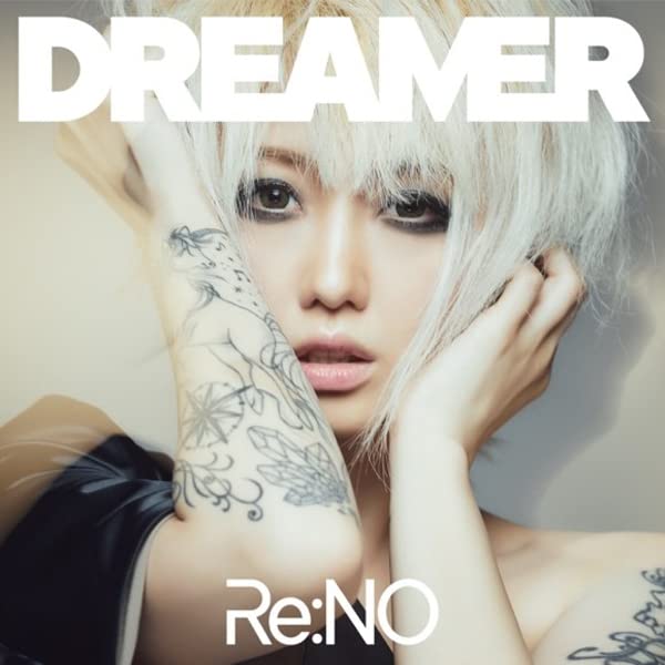 Close-up of Re:NO with short blonde hair, tattoos, and intense gaze.