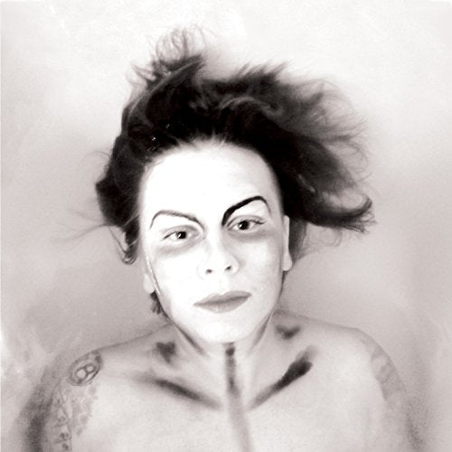 Black and white portrait of a person floating in water, face-on.